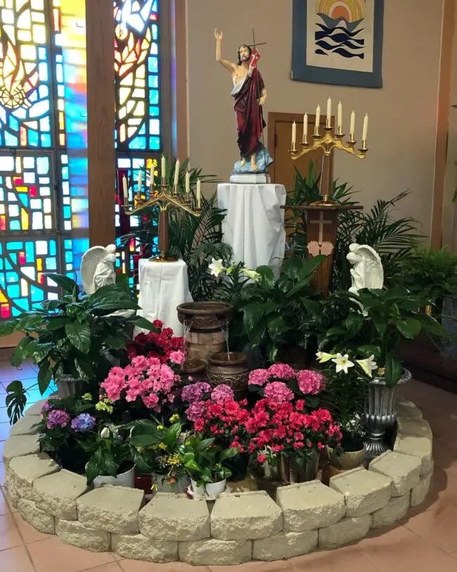 Radiant Floral Oasis Surrounds Christ Statue