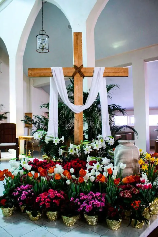 White Draped Cross Adorned with Flowers