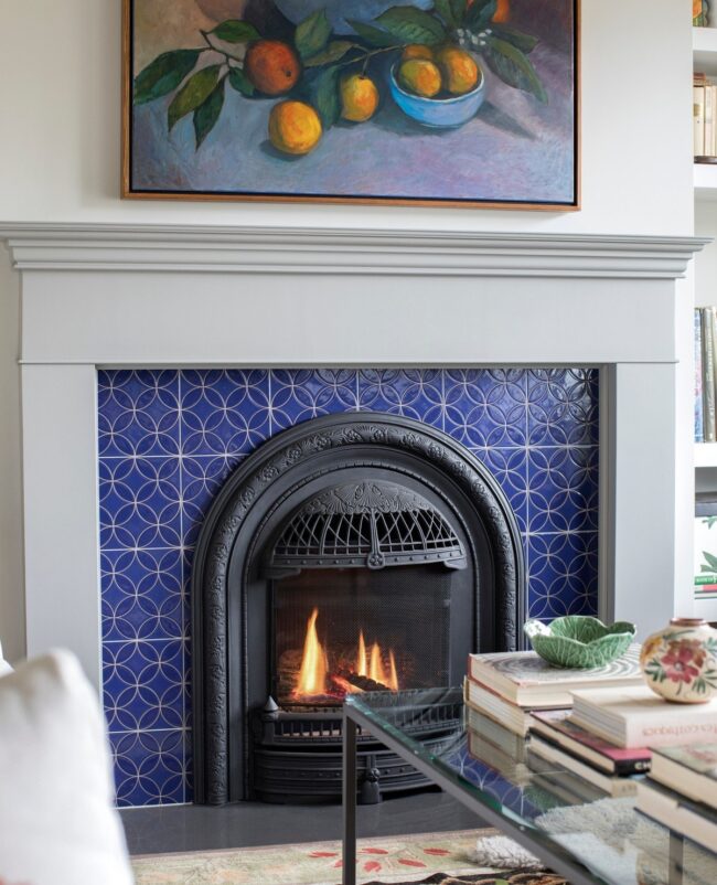 Bold Blue Tiles with Ornate Black Fireplace Insert